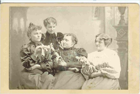 four ladies holding their bananas four ladies holding their bananas